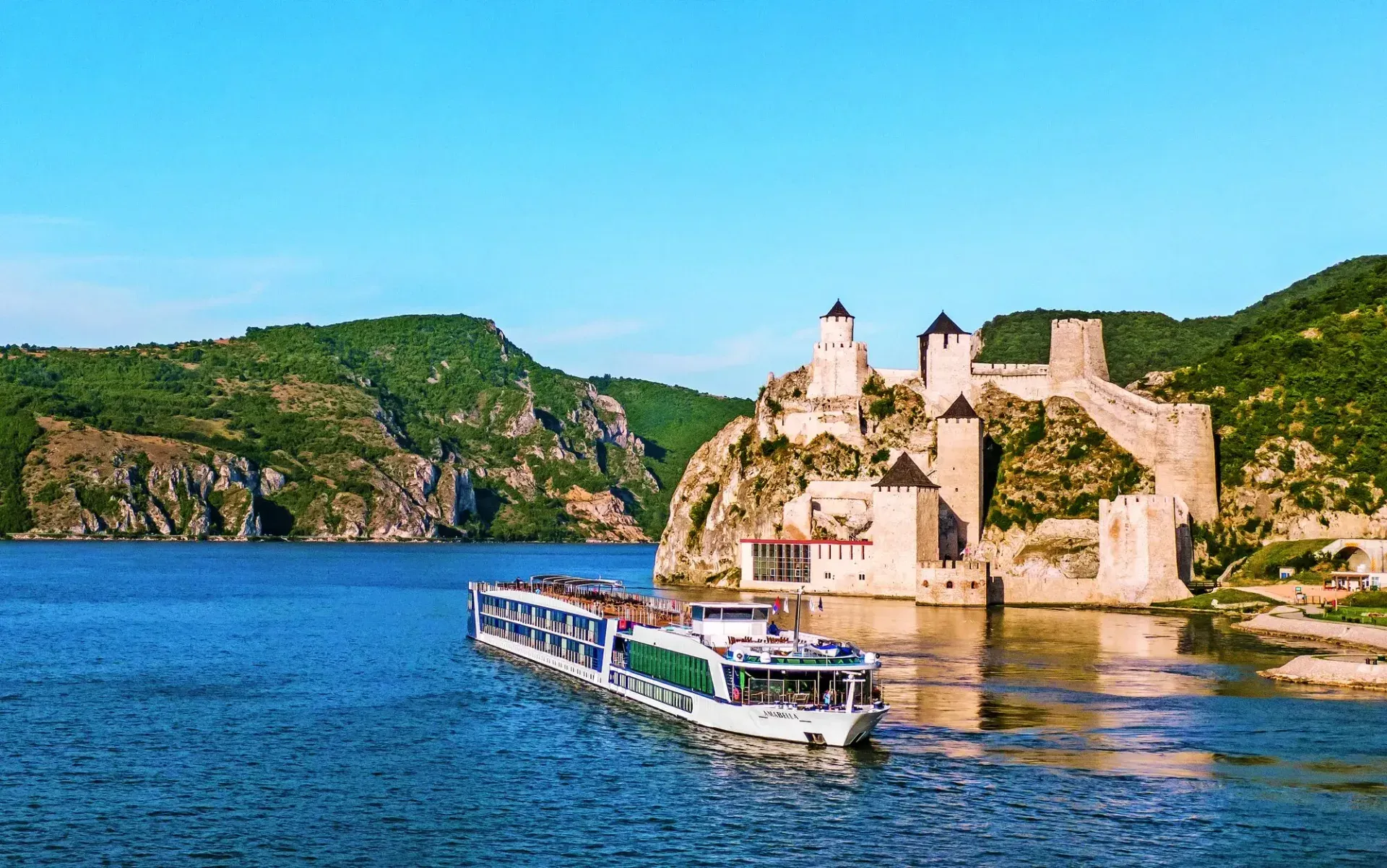 An AmaWaterways river ship passing the hilltop Golubac Fortress on the Danube