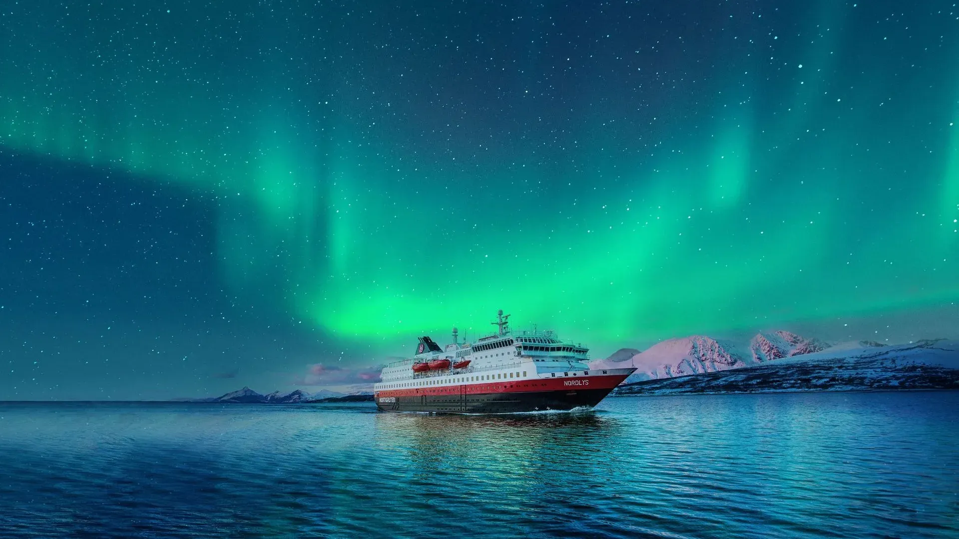 Hurtigruten's MS Nordlys sailing under the Northern Lights off the Norwegian coast
